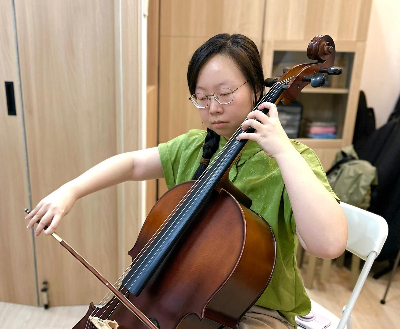 A cello student in a lesson at Bowed Strings